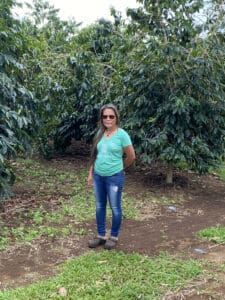 Aroma Coffee Farms - lady standing among coffee trees